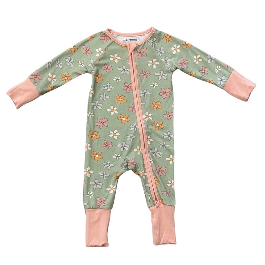Floral-patterned baby onesie with pink accents on a white background