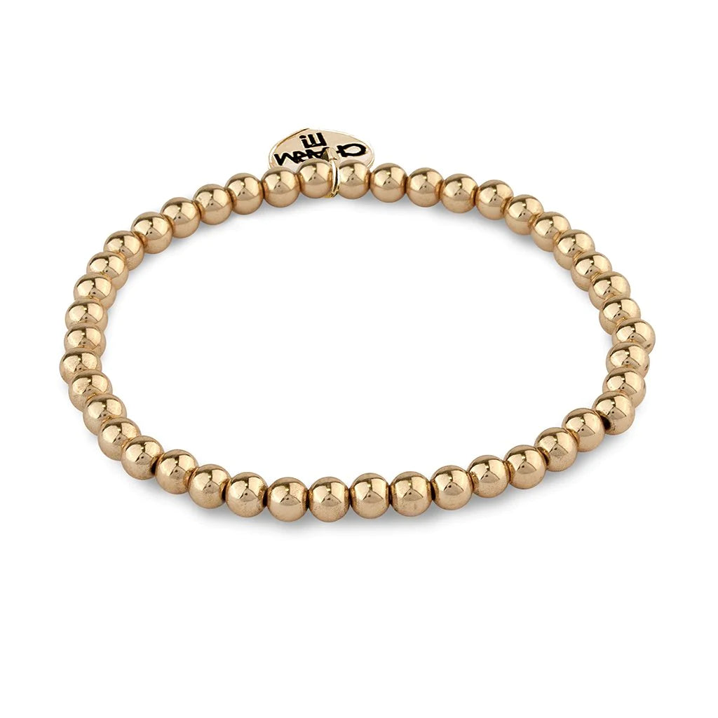 gold bead stretch bracelet with a charm attached