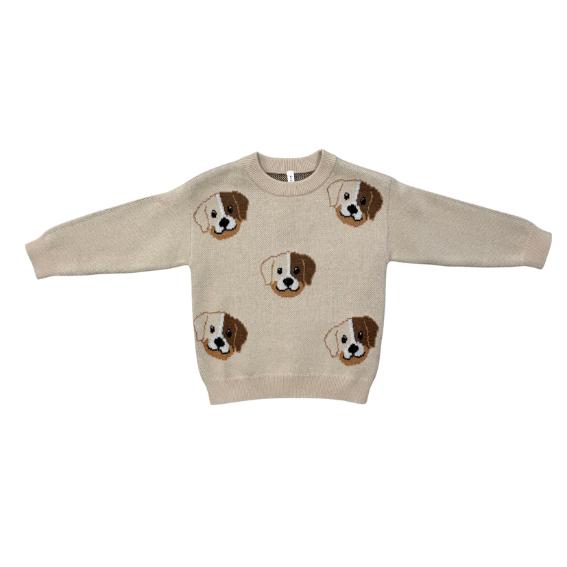 A beige knit crewneck sweater featuring embroidered dog faces in brown, white, and black, displayed flat against a solid white background.