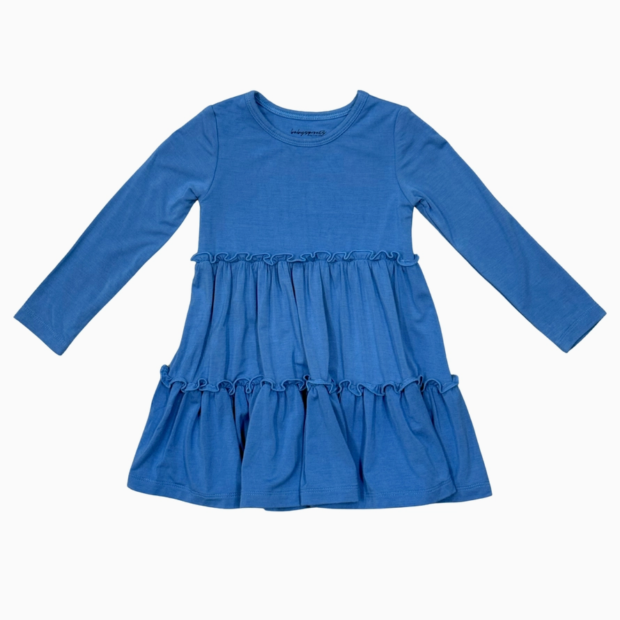 A blue long-sleeve baby dress with a ruffled waist and tiered skirt, laid flat against a white background.