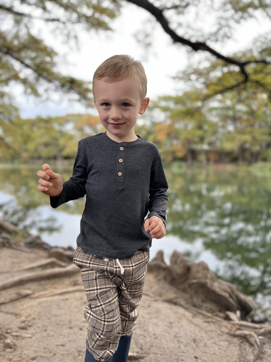 Young boy wearing a grey long sleeve shirt