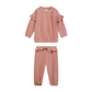 A two-piece children's outfit in dusty rose pink, featuring a long-sleeve top with ruffled shoulder details and matching ruffled drawstring pants.