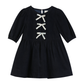Deep blue dress with white bows on the front.
