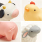 Four animal figurines including a cow, chicken, pig, and sheep on a white background.