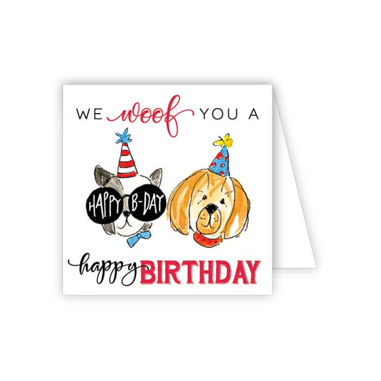 Birthday card with two dogs wearing party hats and text 'We woof you a happy birthday'.