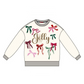 A white crewneck sweatshirt featuring a festive Christmas design with the word 'Jolly' in gold script, surrounded by colorful embroidered bows in green, pink, and red, with gray ribbed cuffs, hem, and collar.