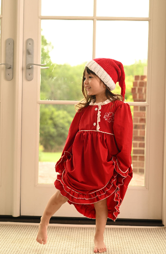 a young girl wearing a red ruffled nightgown