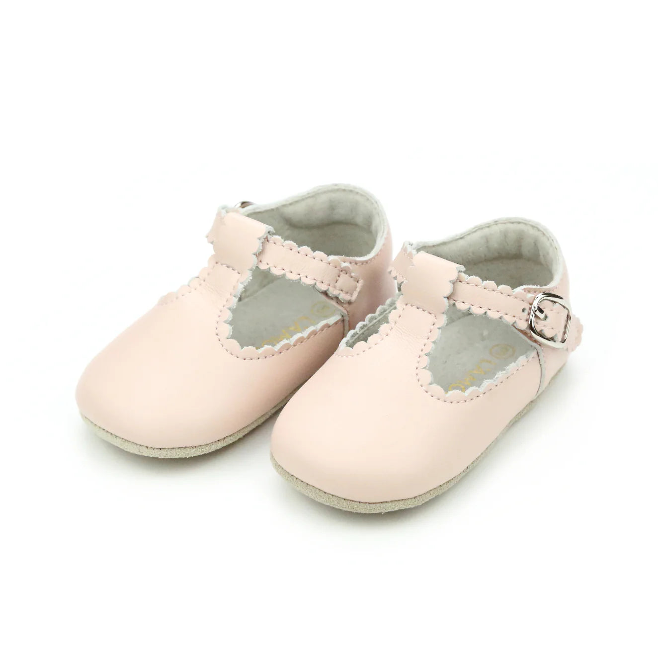 Pair of light pink baby shoes with gray soles