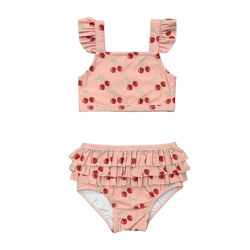 Pink two-piece swimsuit with cherry pattern on a white background