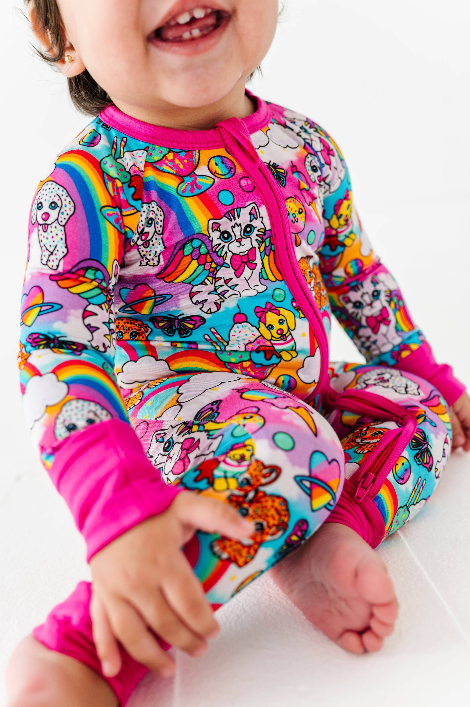 Child wearing a colorful swimsuit with cartoon characters on a white background