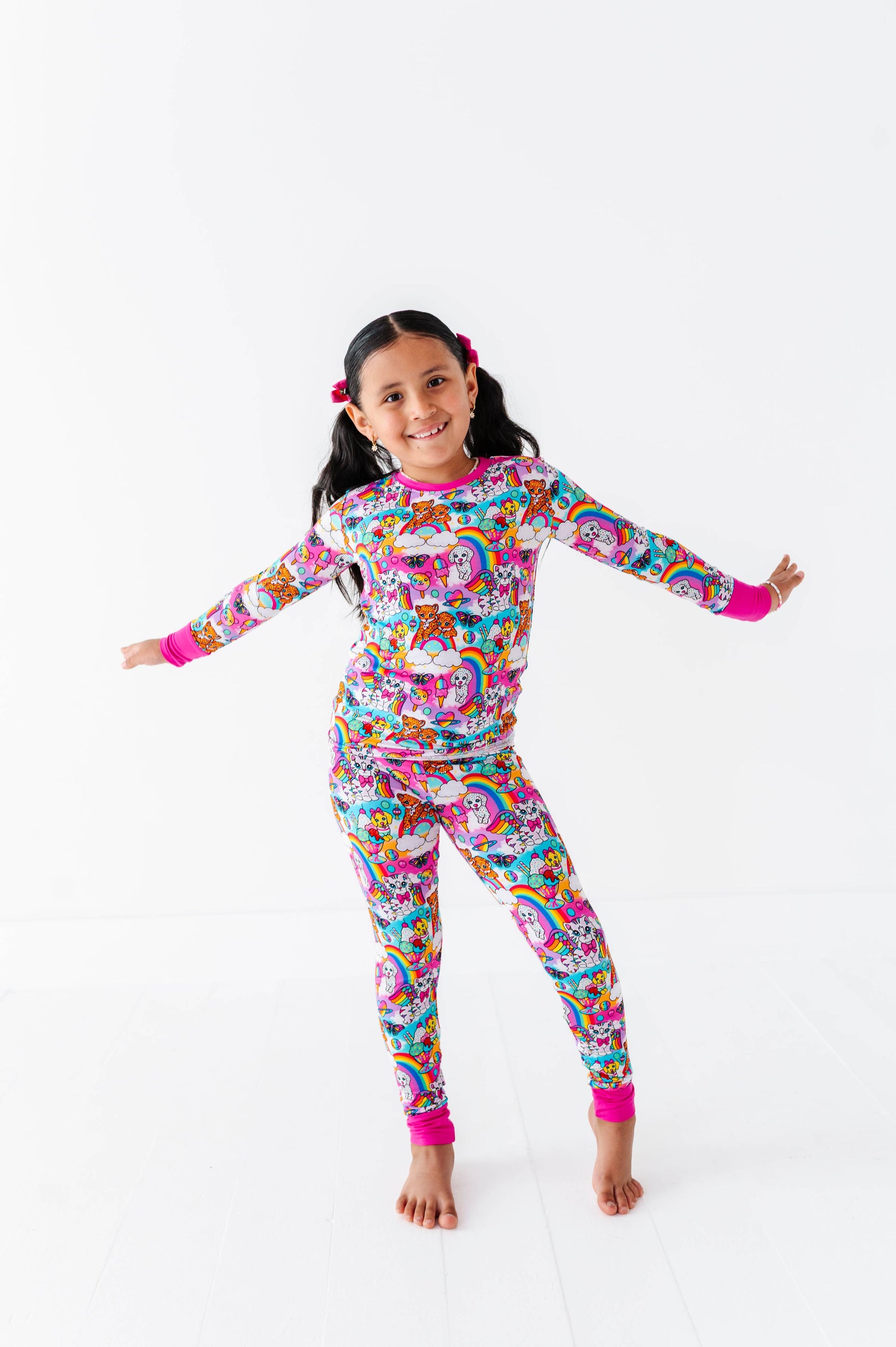 Child wearing a colorful unicorn-themed onesie on a white background