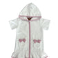 White hooded towel with pink trim and bows