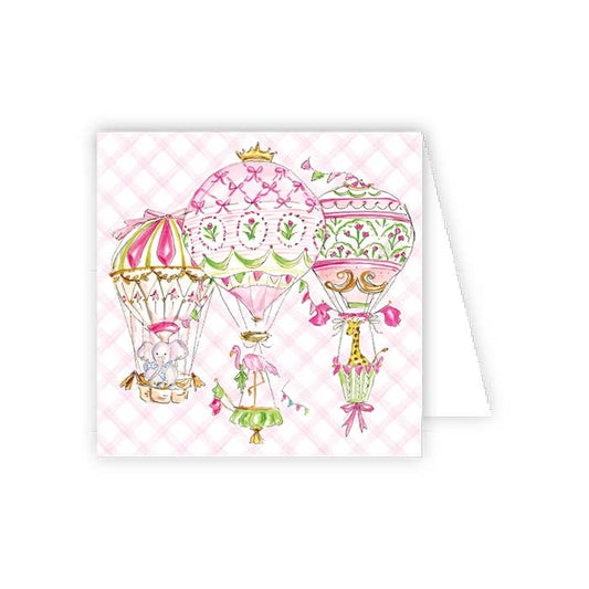 Greeting card with pink hot air balloons and baby elements on a checkered background