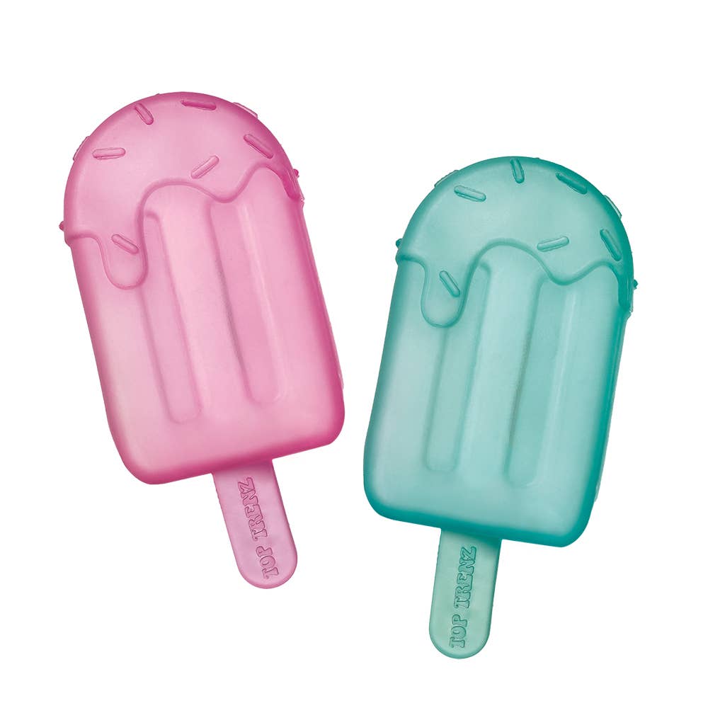 Pink and green ice cream molds on a white background