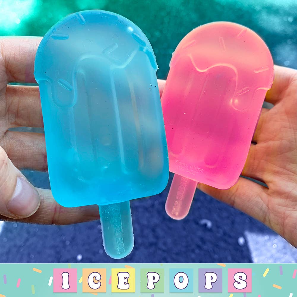 Two blue and pink ice cream popsicles held in a hand with a colorful 'ICE POPS' text at the bottom.