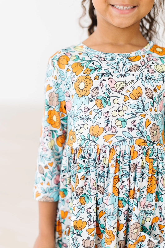 a floral children's's dress with blue and orange accents