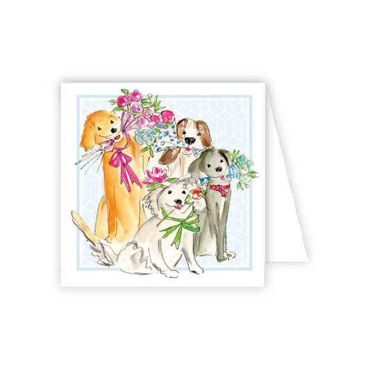 Four puppies holding flowers on a card