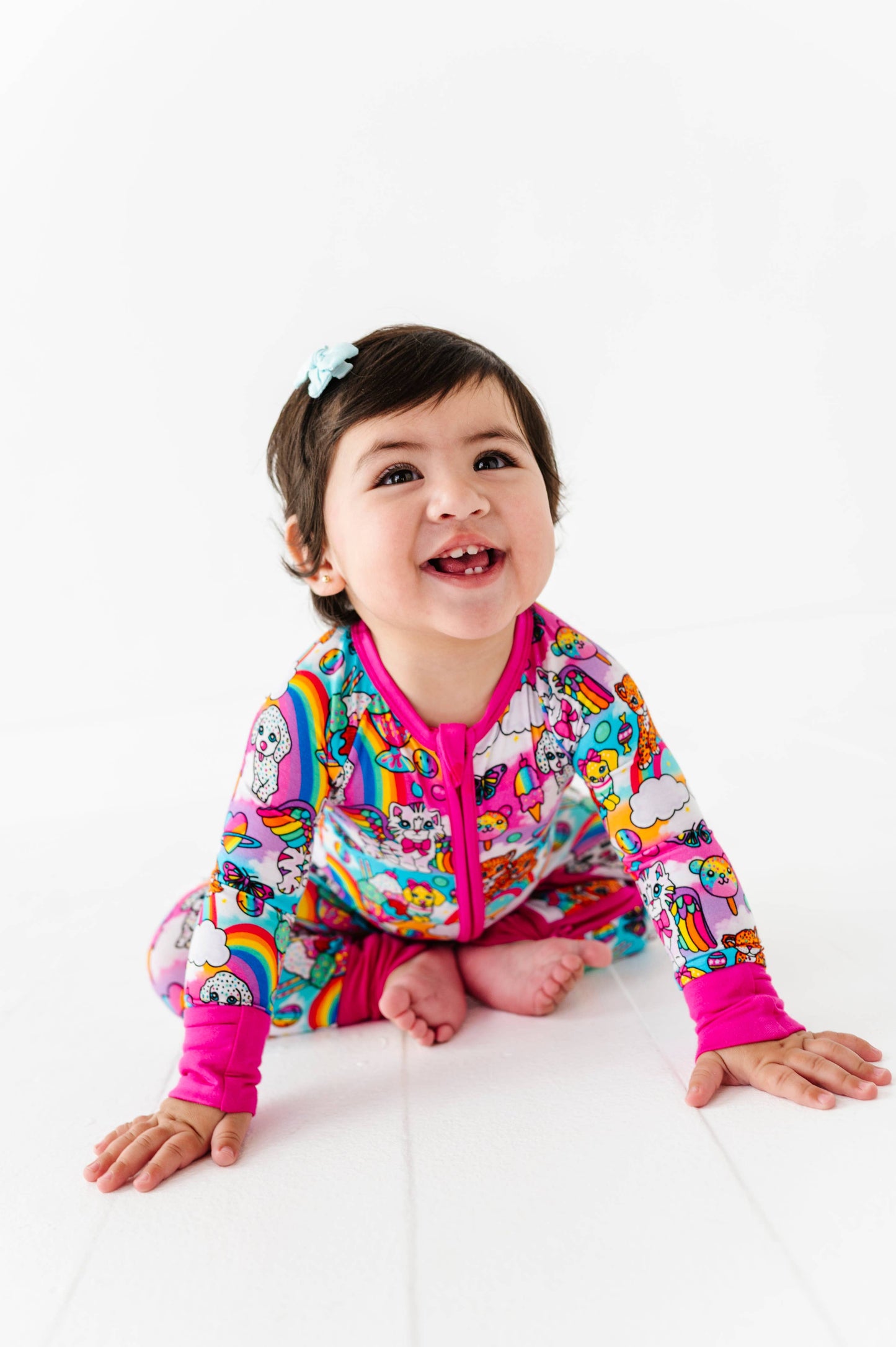 Child wearing a colorful jacket with cartoon designs on a white background