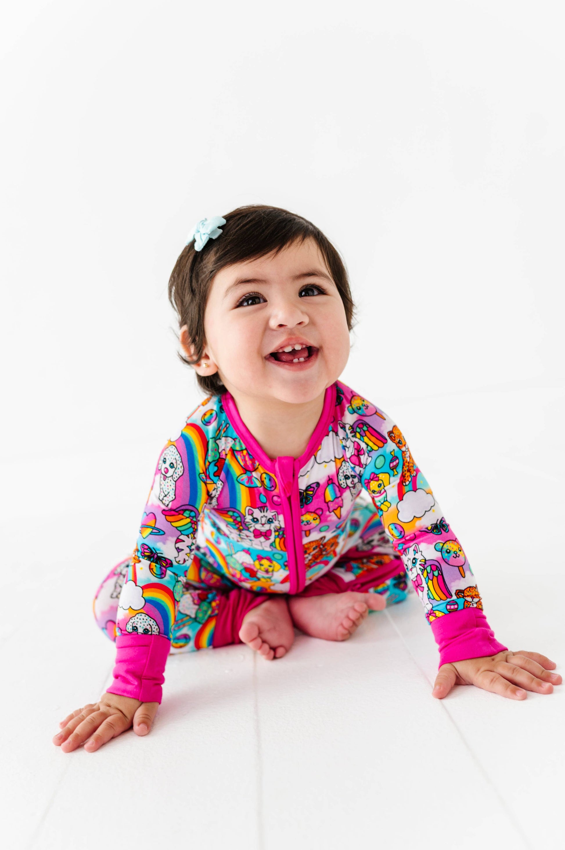 Child wearing a colorful jacket with cartoon designs on a white background