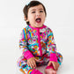 Child wearing a colorful outfit with cartoon characters on a white background