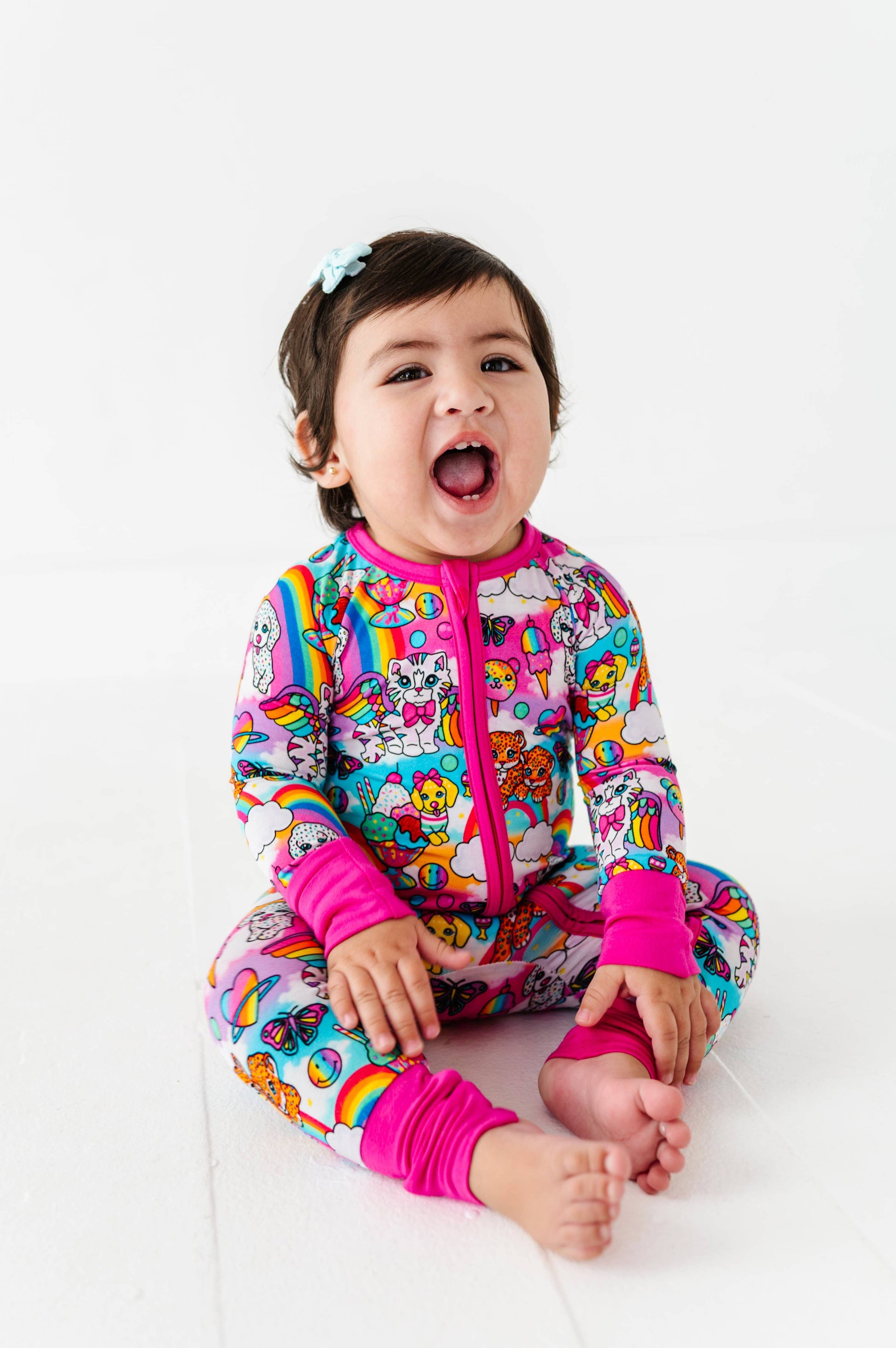 Child wearing a colorful outfit with cartoon characters on a white background