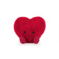 Red heart-shaped plush toy with a smiley face 