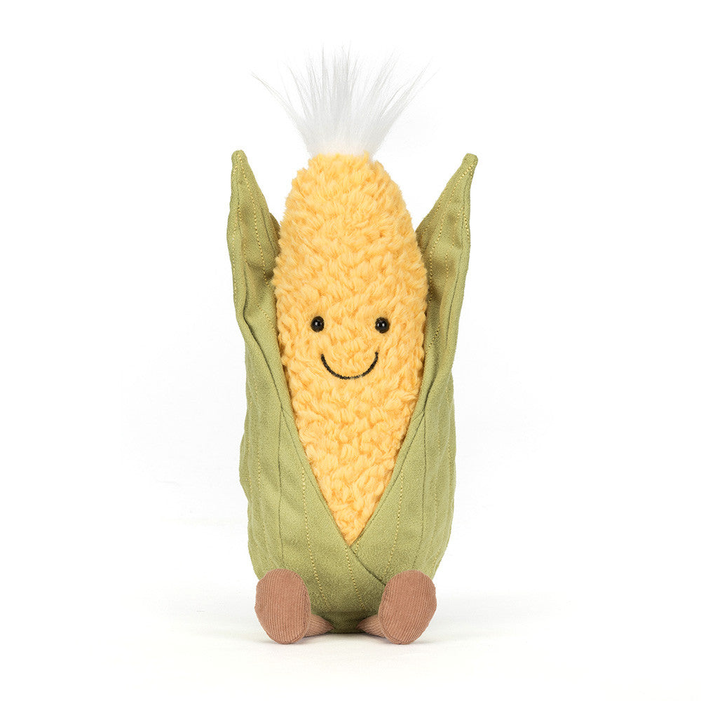 Plush toy resembling a corn on the cob with a smiling face