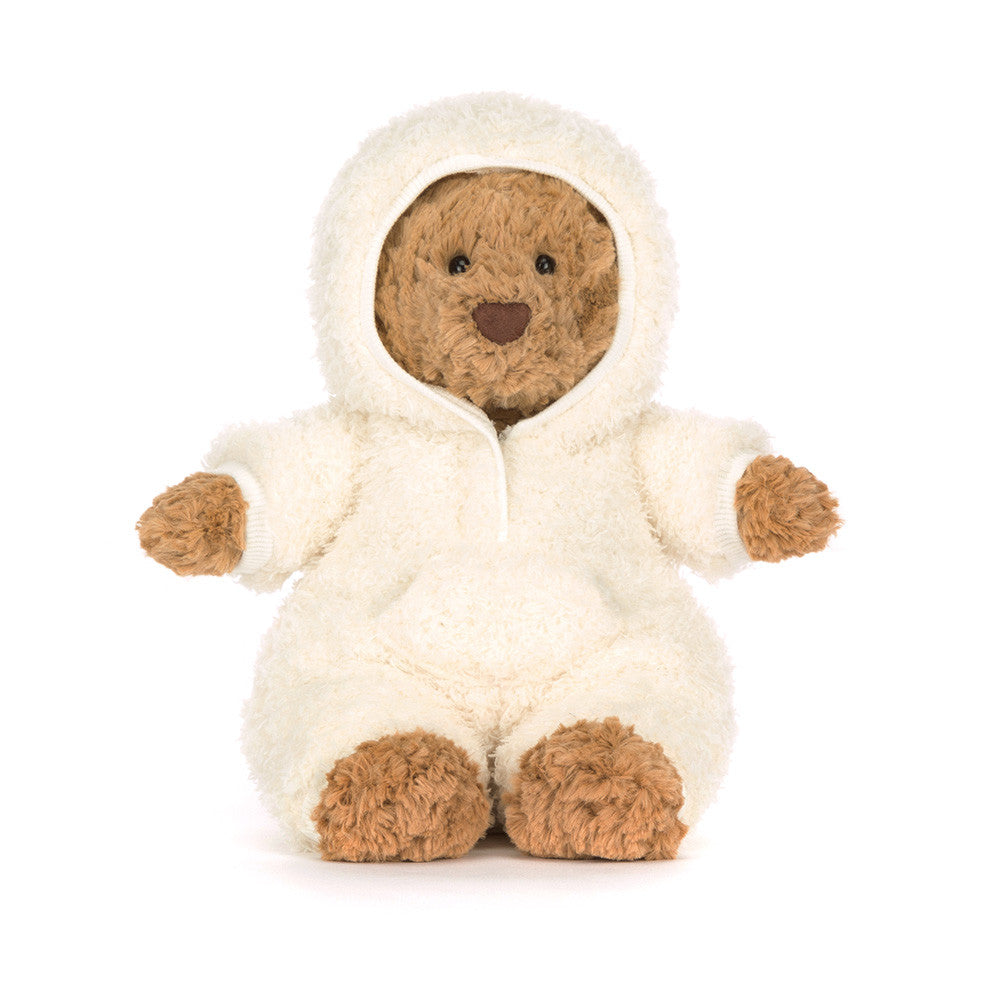 Stuffed bear in a white onesie with brown paws 