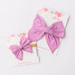 bright lilac hair bows on a floral card