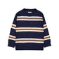 A navy blue crewneck sweater with horizontal stripes in beige, white, and light brown