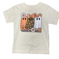 An off-white short-sleeve kids' t-shirt laid flat on a brown wood floor, featuring a graphic of three cute ghosts in orange, brown, and white with flowers.
