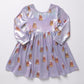 A long-sleeve iridescent lavender dress with an allover candy corn print