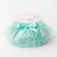 Turquoise tutu skirt with a bow on a white background