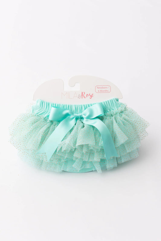 Turquoise tutu skirt with a bow on a white background