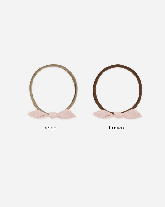 Two headbands with bows, one beige and one brown