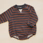 A baby long-sleeve romper with horizontal rust brown and dark gray stripes