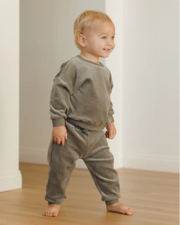 Child wearing a green sweatshirt set