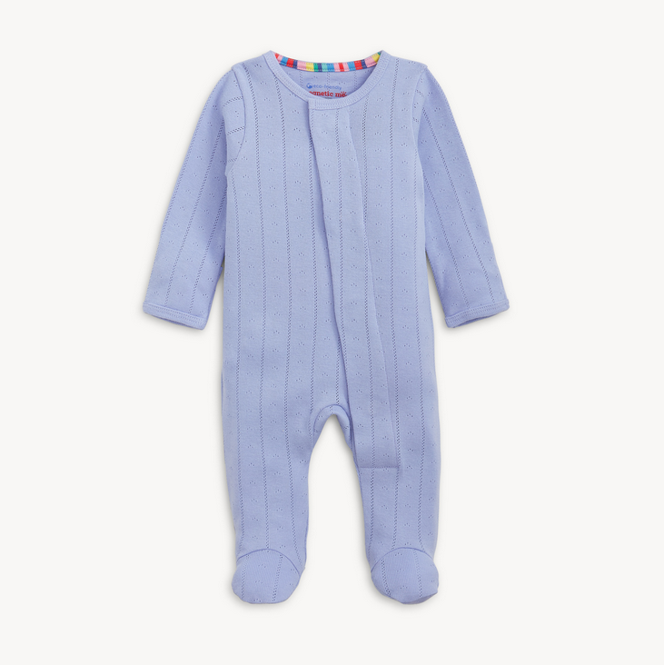 Blue baby onesie with a colorful label on a white background