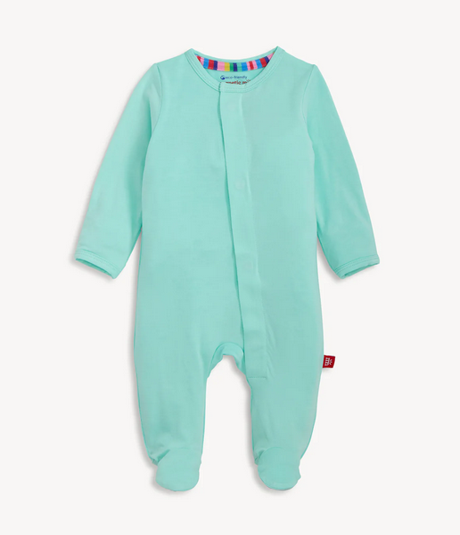 Mint green baby onesie with a colorful label on a white background