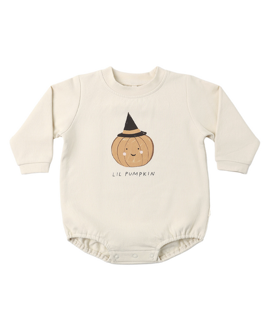 A cream-colored long-sleeve baby bodysuit featuring a cute cartoon pumpkin wearing a black witch hat with the text 'LIL PUMPKIN' printed below it, displayed on a clean white background.
