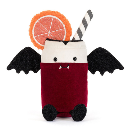 A cute plush toy shaped like a vampire drink can with bat wings, black feet, small vampire teeth, and a striped straw. It has an orange glittery grapefruit slice decoration on top, set against a plain white background.