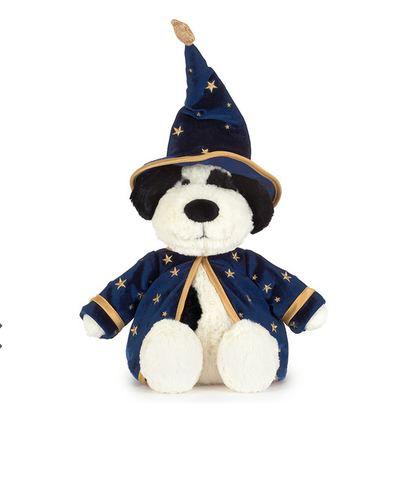 A plush dog toy dressed as a wizard, featuring a navy blue velvet robe with gold star patterns and trim, a matching pointed wizard hat, and a white plush face and paws.