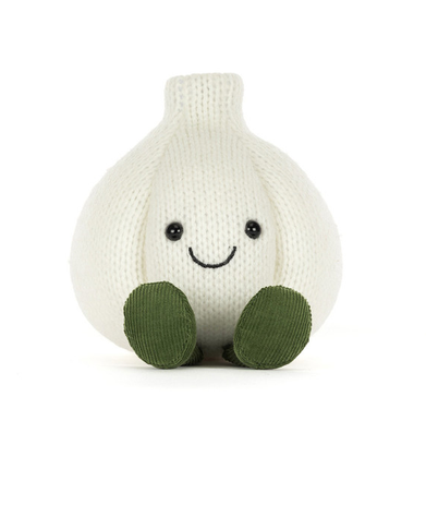 A knitted garlic plush toy in off-white with olive green feet and a simple black embroidered smiley face, photographed on a clean white background.