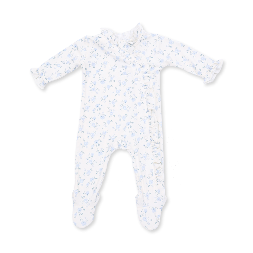 A baby long-sleeve footed sleeper in white with a light blue floral pattern, featuring ruffled trim on the collar and cuffs, laid flat on a white background.