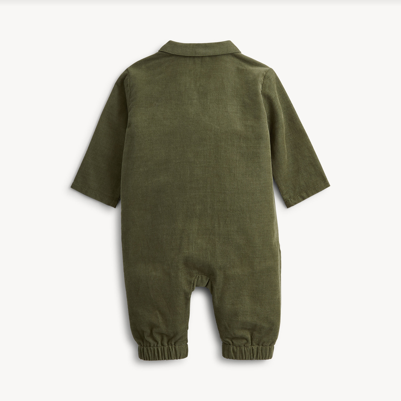 An olive green long-sleeve baby jumpsuit shown from the back, featuring a collar and elasticized leg cuffs, photographed against a clean off-white background.
