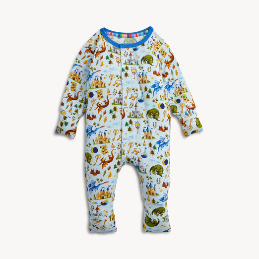 A baby footed one-piece sleeper with long sleeves and legs, featuring a colorful cartoon animal and landscape print on a white background with a blue collar.