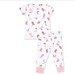 A two-piece children's pajama set featuring a white short-sleeve top and matching pants with an all-over cowboy boot print in pink, brown, and blue, finished with solid pink cuffs.