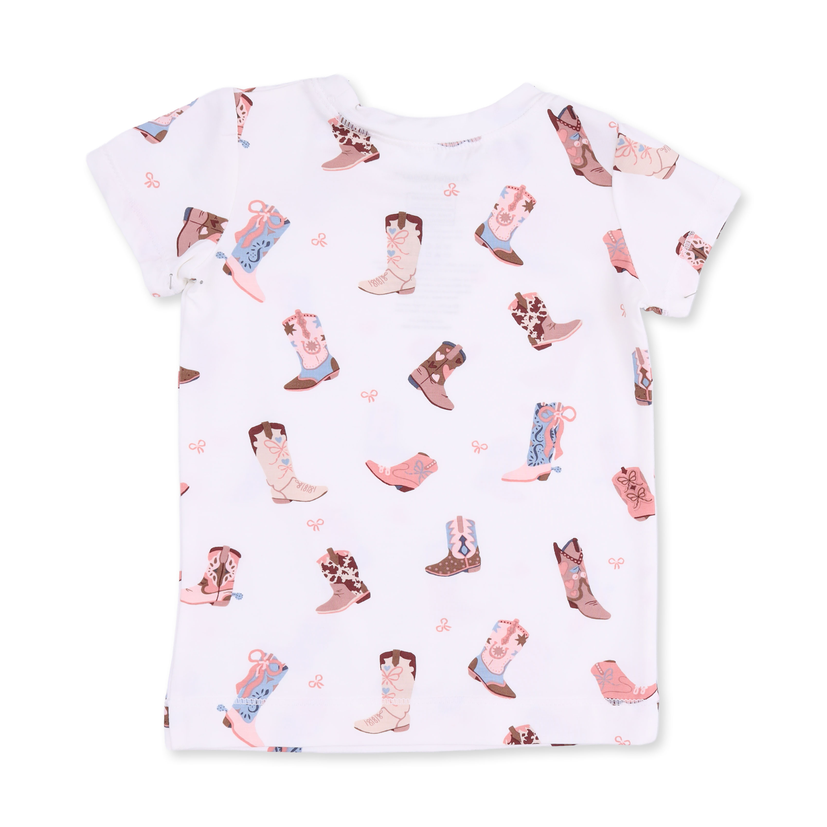 A white short-sleeve baby tee with an all-over print of cowboy boots in pink, brown, and blue, along with small pink bow motifs.