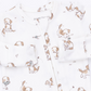 White long-sleeve baby pajama top with a cute brown and beige puppy print, featuring a snap-button front and a visible Angel Dream brand label.