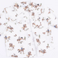 A white long-sleeve button-up shirt with a cowboy and western-themed print featuring brown horses, riders, and small desert motifs, laid flat on a white background.